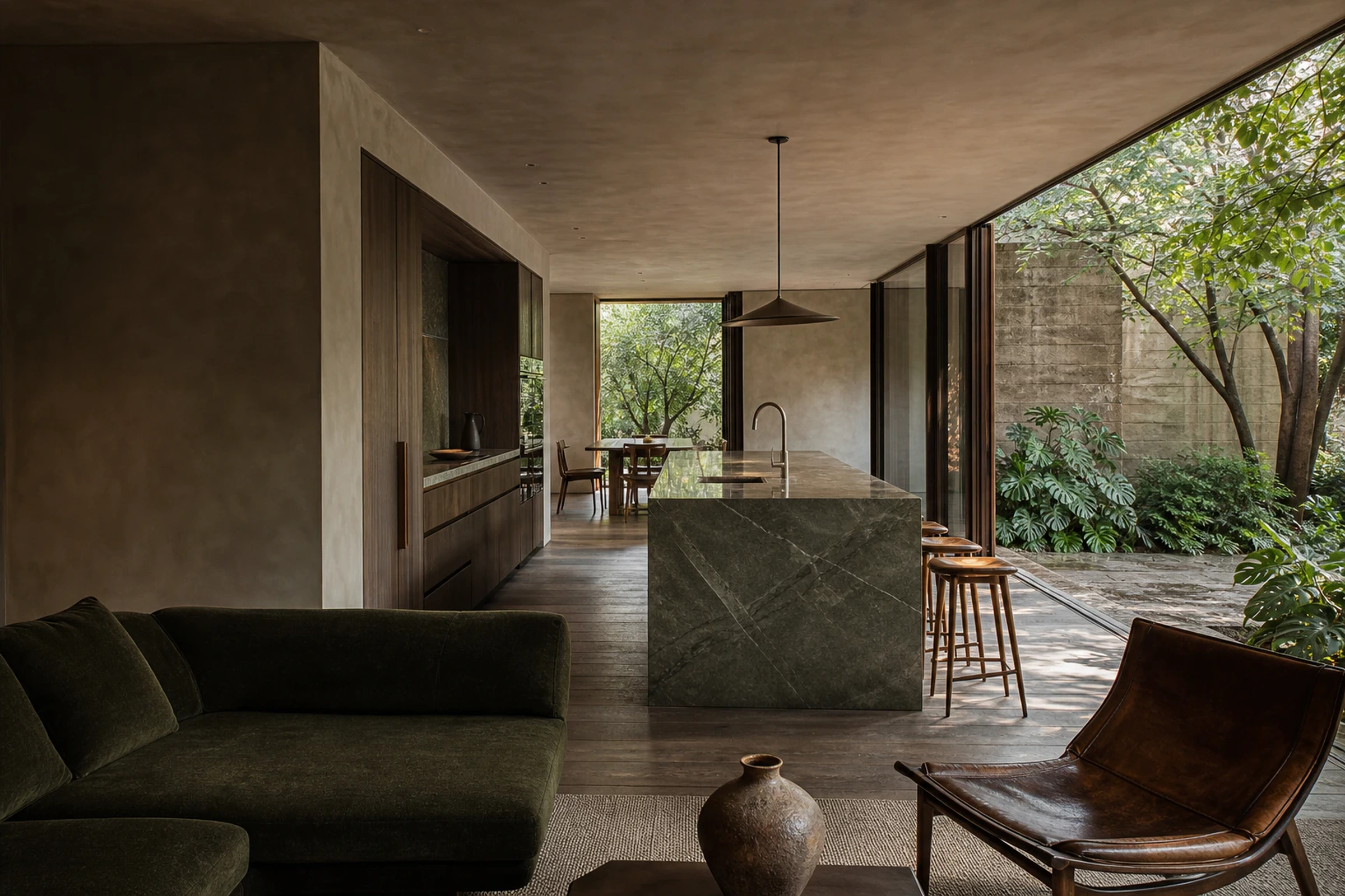 Garden residence with a monolithic stone kitchen, smoked timber joinery and collected living furniture