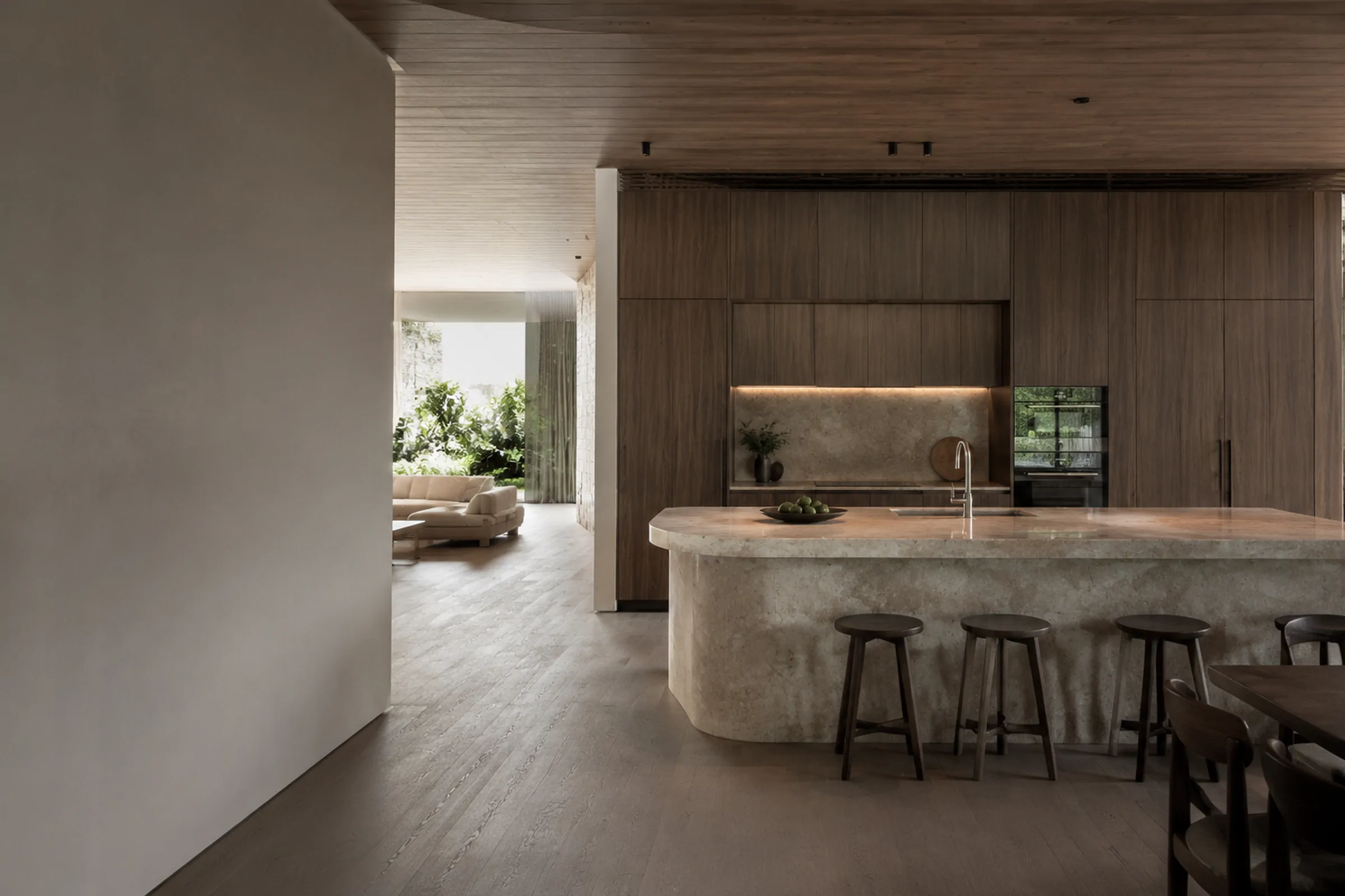 Architectural kitchen with dark timber cabinetry and a monolithic stone island